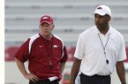 Arkansas Coach Bobby Petrino (left) and offensive coordinator Garrick McGee are hoping to see just how tough the Razorbacks are mentally and physically during today’s 9 a.m. scrimmage at Reynolds Razorback Stadium in Fayetteville.