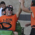 Duke Mobley, an assistant coach at Gravette, gets a high-five from a player Friday during practice.