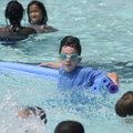 KEEPING COOL Gray Fullerton, 7, plays Friday with other children in the water at Wilson Pool in Faye...