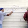 GRAFFITI REMOVAL Leonard McCoy, left, with the Springdale Public Works department, and Dave Nation, ...