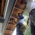 Alfredo Aginaga, left, and Merlin Villatoro, both with Garcia Siding, install siding Friday outside ...