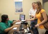 Lisa Smith (left), an assistant financial aid coordinator with the state Department of Higher Education, discusses the status of a lottery scholarship application with University of Central Arkansas nursing school junior Whitney Bowman and her father, Bob Bowman.