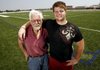Springdale Har-Ber offensive lineman Brey Cook (right), who has grown up without the involvement of his biological father, has embraced the values of hard work and dedication exhibited by his grandfather Warren Cook (left), according to Har-Ber Coach Chris Wood.