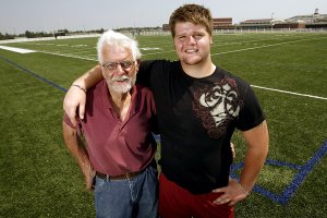 Springdale Har-Ber offensive lineman Brey Cook (right), who has grown up without the involvement of his biological father, has embraced the values of hard work and dedication exhibited by his grandfather Warren Cook (left), according to Har-Ber Coach Chris Wood.