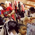 BACK TO SCHOOL - Juana Vasquez, left, of Rogers shops Saturday for clothes for her daughter, Emili, ...