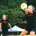 DIG FOR DIABETES - Haley Perry, 13, of Bentonville, right, digs the ball as her “Champions” teammate...