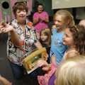 Gail Pianalto shows a caterpillar to some youngsters at a Fayetteville preschool on Aug. 3. Children...