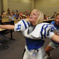 MOUNTIE MOMS - Karen Klane, right, helps Sheila Harrell put on football equipment Saturday during th...