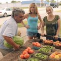 James Poulos, from left, grabs a water melon and a cantaloupe he bought from Ashley Poll and Kayla L...