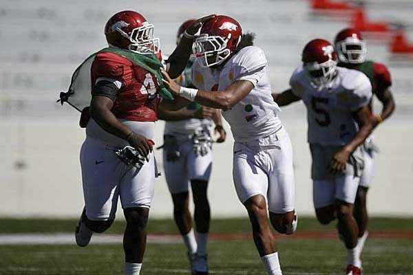arkansas senior anthony leon fends off freshman jatashun beachum during