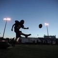 Fayetteville kicker Max Coffin follows through with a kickoff while practicing under the lights as t...