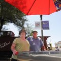 Maggie and Joe Neblett wait Monday for customers at Maggie’s Hot Dogs cart in downtown Rogers. Monda...