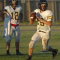 Prairie Grove sophomore quarterback Cooper Winters rolls out during the Tigers’ practice Tuesday mor...