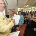 Gary Morris, left, director of Retired Senior Volunteer Programs, prepares to open envelopes contain...