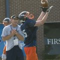 Rogers Heritage wide receiver Mac Olinger catches a ball as Offensive Coordinator Chad Harbison look...