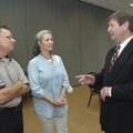 Joe Mills, right, talks Tuesday with Jim Moore and Brenda Wilson Kelly after Mills announced he will...