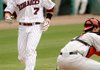 Arkansas’ Zack Cox crosses home plate ahead of the throw home to Georgia catcher Christian Glisson in the first inning April 17 in Baum Stadium in Fayetteville.