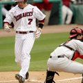 Arkansas’ Zack Cox crosses home plate ahead of the throw home to Georgia catcher Christian Glisson i...
