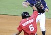 Northwest Arkansas shortstop Chris McConnell throws to first base for a double play as Frisco’s Guilder Rodriguez slides into second base Wednesday in Arvest Ballpark in Springdale.