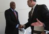 Rick Wade, deputy chief of staff at the U.S. Department of Commerce, greets Dr. Curtis Lowery, chairman of the Department of Obstetrics and Gynecology at the University of Arkansas for Medical Sciences, after announcing a $102 million grant to expand broadband Internet access in the state Wednesday in Little Rock.