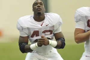 University of Arkansas linebacker Chris Smith stretches out during practice Tuesday afternoon in Fayetteville.