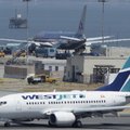 American Airlines Flight 24, bound for New York's John F. Kennedy Airport, top, sits on a runway at ...