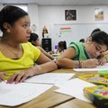Stephanie Herrera, left, 10, and Emily Castro, right, 11, work Thursday on a drawing in Heidi Hollan...