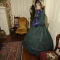 Grace Costello, a 13-yearold living history actress, shows visitors a bullet hole made in the door o...