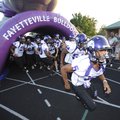  Fayetteville players run onto the field during the Dogs’ Spirit Night activities Friday at Harmon F...