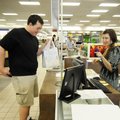 Brandy Wasem, right, talks to Matthew Daniels after he made a purchase at the Samaritan Shop of Roge...