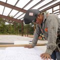 Angel Estrada looks at welding plans Tuesday on the site of the 128-person minimum security barracks...