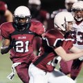  Springdale High’s Rahmon Taylor, left, runs through a hole in the defense during an intrasquad scri...
