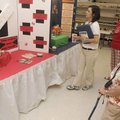 Education booth superintendent Ava Griffin, right, watches Tuesday while Elizabeth McGinley, left, a...