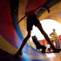 Amanda Ridley, 13, of Bentonville negotiates the spinning exit of the “Are Town” funhouse Saturday a...