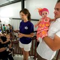 Johnny McDaniel, right, of Bella Vista and his 8-month-old daughter, Brinklee, wait along with Sonja...