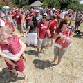 Kate Louton of Springdale holds her 3-year-old son, Braxton, on Saturday while standing in a long, w...
