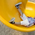 Jesse Morones, 6, of Rogers goes backward down a spiral slide Tuesday at Lake Atalanta Park in Roger...