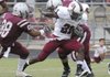 Springdale High’s Rahmon Taylor breaks past Siloam Springs defenders Tuesday in a scrimmage at Siloam Springs.