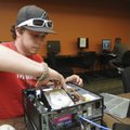 Calvin Carl, a work study student at NorthWest Arkansas Community College, checks a hard drive Wedne...