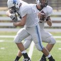 Springdale Har-Ber’s Gordon Welch, left, practices a fake hand-off drill with John Vaughn on Tuesday...