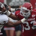 Arkansas running back Dennis Johnson stiff-arms Mississippi State’s Robert Elliott during the first ...