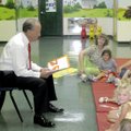 STORYTIME - Bentonville Mayor Bob McCaslin reads to students at the Helen R. Walton Children’s Enric...