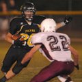 Prairie Grove’s Weston Bartholomew tries to get around Huntsville’s Jeff Neal on Thursday at Prairie...