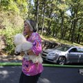 HOUSE FIRE - Joni Mayes holds her dog Gizmo on Thursday while Fayetteville firefighters extinguish a...