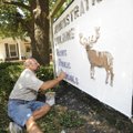 SIGN MAKEOVER - Jon Hoodenpyle, bus driver and grounds maintenance worker for Elkins Public Schools,...