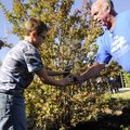 MAKE IT RAIN - Sheldon Patrick, left, 9, helps Mike Hicklin, landscaping supervisor with Springdale ...
