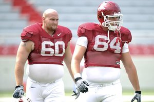 Arkansas freshman Travis Swanson (64) is battling junior Seth Oxner (60) for first-team center after taking advantage of a redshirt season to get bigger and stronger. “It’s competition, and it makes everybody better,” Oxner says.