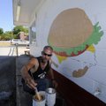 BIGGER BRIGHTER BURGER - Paul Rasmussen of Rogers paints a burger Friday at Brenda’s Bigger Burger o...