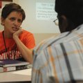 Erin Covey, left, a new teacher at Heritage High School in Rogers, speaks Friday with student Manoj ...