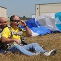 Geoff Lewis, right, a captain with the Siloam Springs Police Department, lands safely on the ground ...